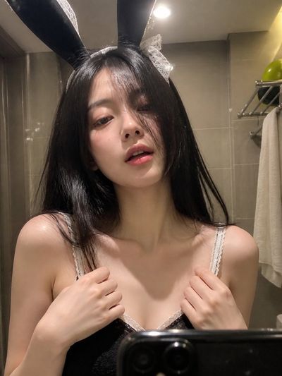 Intimate Bathroom Selfie with Playful Bunny Ears