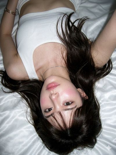 Serene Upside-Down Portrait in Soft Bedroom Light