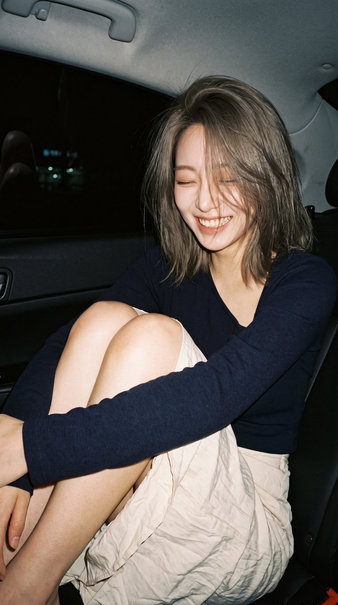 Capturing an Unposed Mid-Laugh Portrait in a Dimly Lit Car Interior