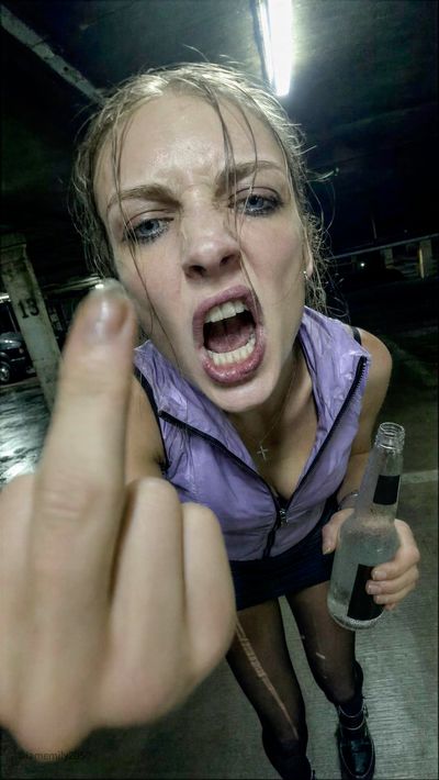 Woman's furious shout distorted by ultra-wide lens in green light