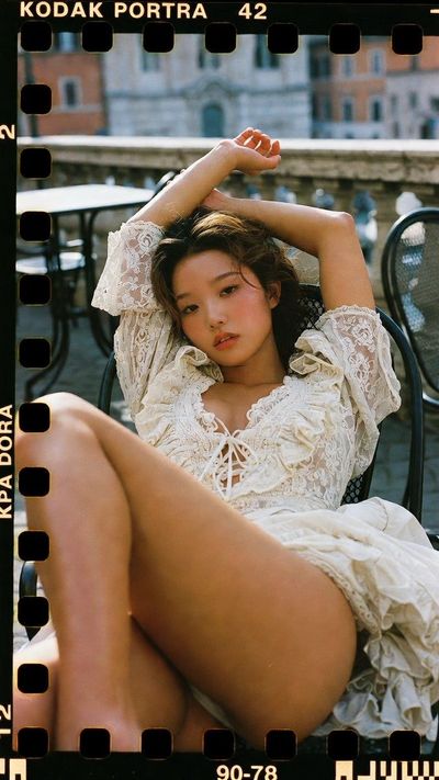 A Victorian beauty reclines on a Rome cafe terrace in warm film light.