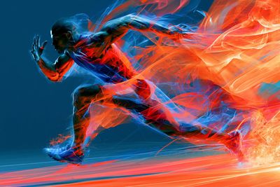 A dancer leaps within a radiant energy field of electric blue and magenta