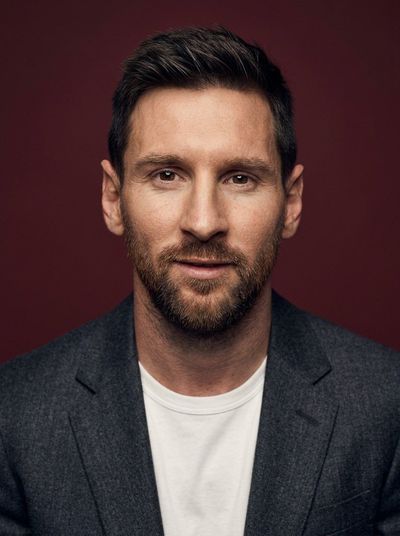 Professional portrait with charcoal blazer and soft studio lighting.