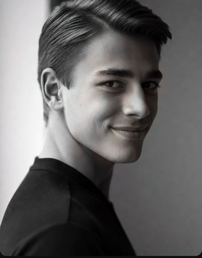 Young man's confident smile in a classic black and white portrait