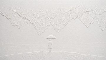 Blind embossed paper artwork casts subtle white shadows across textured surface