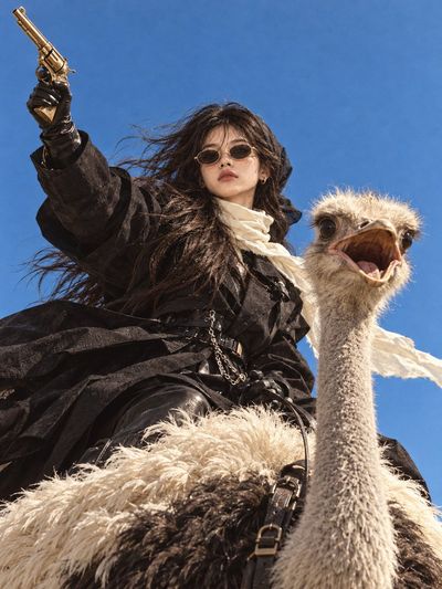 Cinematic High-Fashion Editorial Featuring a Bold Woman on an Ostrich