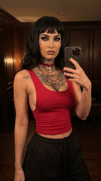 Edgy Megan Fox selfie with dark gothic makeup and tattoos
