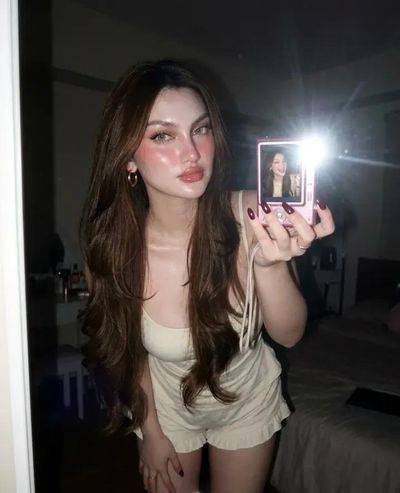 Candid woman in dark room with flash and glossy lips
