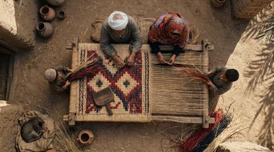 Top-down view of Fayoum mat weavers with halfa grass and cat