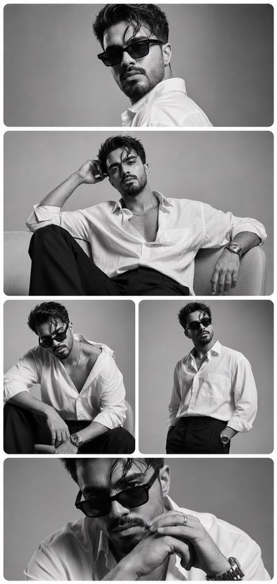 A man in black sunglasses poses for a luxury editorial portrait