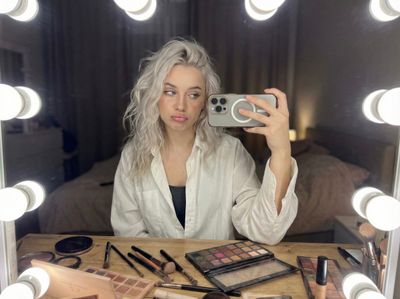 Mid-Makeup Glam Chaos in Soft Vanity Light
