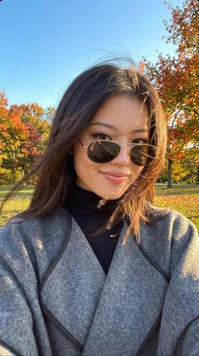 Candid autumn selfie with windblown hair and warm golden light