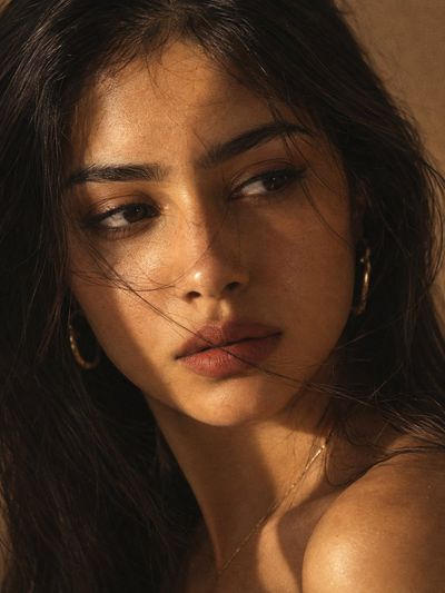 Golden Sunlight Graces a Woman's Face With Tangled Strands
