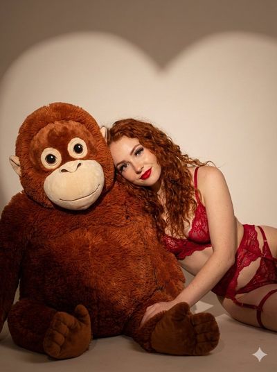 Cozy Affection: Red-Haired Beauty & Plush Orangutan