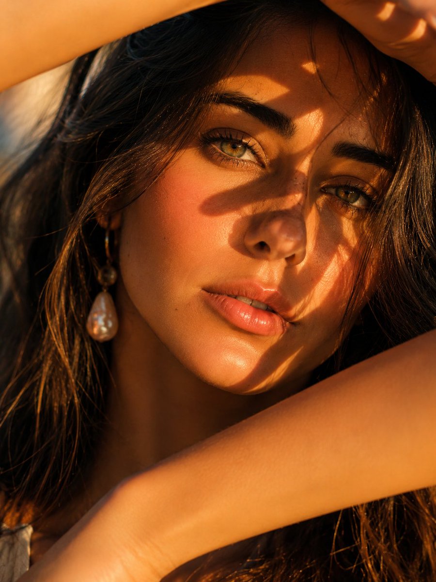 Golden hour sun casts artistic shadows across a woman's face