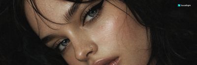 A close-up portrait with dramatic eyeliner and glossy lips