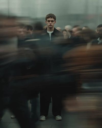 Still Defiance: Sharp Focus Amidst Urban Blur