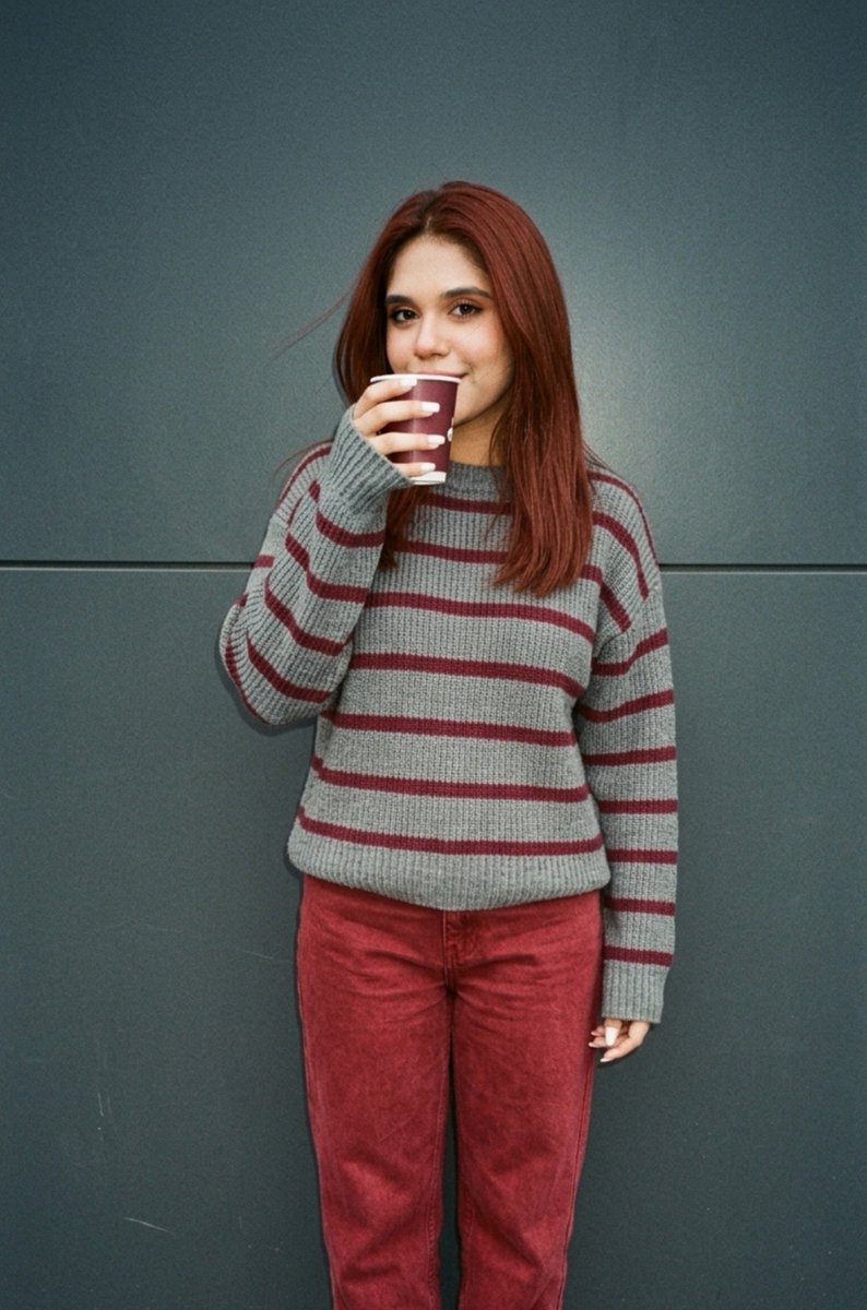 Cinematic close-up of girl drinking iced latte against grey wall