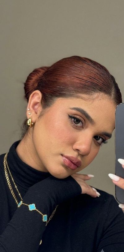 A young girl captures a moody mirror selfie with layered hair