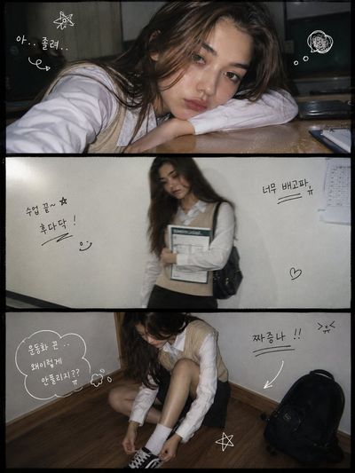 A girl rests her chin on a desk in a beige vest