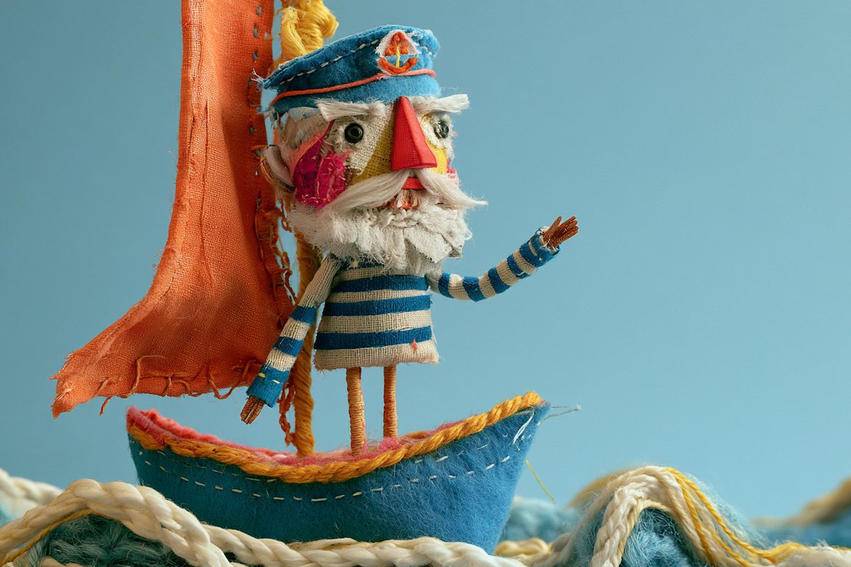 Whimsical Stitched Fabric Creature Poses on Handmade Textile Base