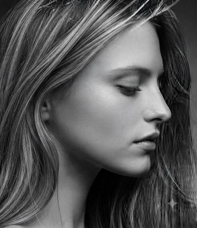 Serene side profile woman with closed eyes in soft light