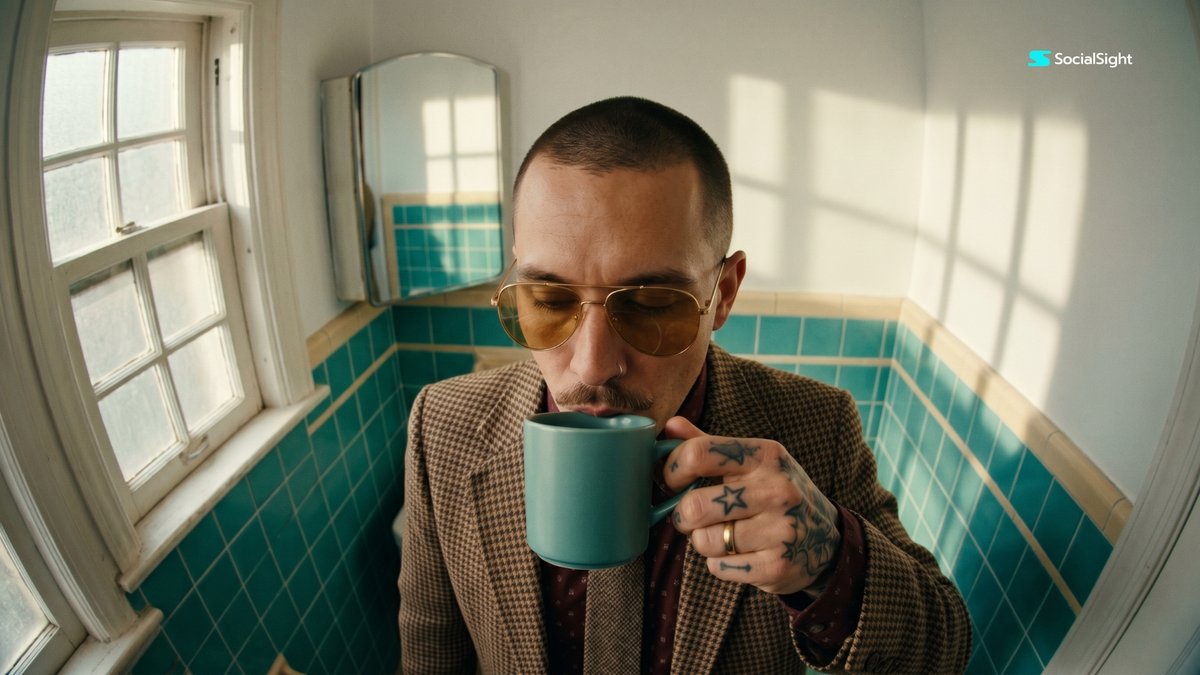 Man sips espresso in vintage bathroom with fisheye lens