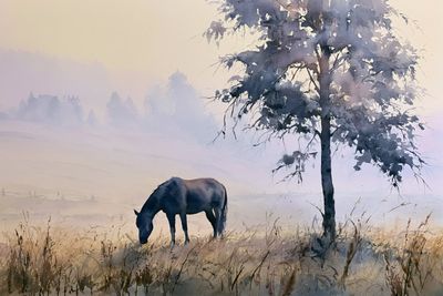A shepherd tends his flock in a misty morning pasture