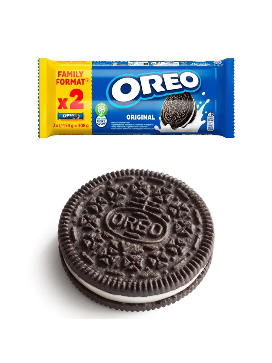 Oreo cookies splash dynamically into milk against deep blue background