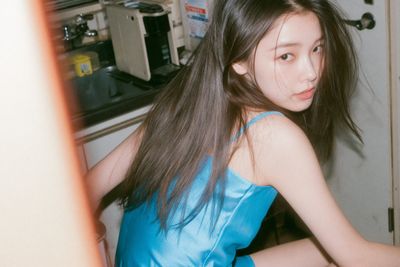 Neon blue satin dress on a Japanese woman in a pantry