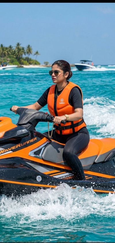 Confident woman rides a jet ski across vivid blue ocean waves.