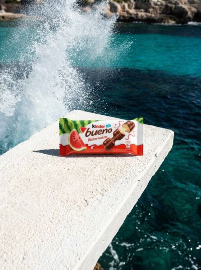 Nano banana pro stands on white concrete above turquoise sea