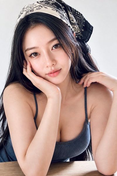 Elegant woman in silk scarf glances back with soft smile