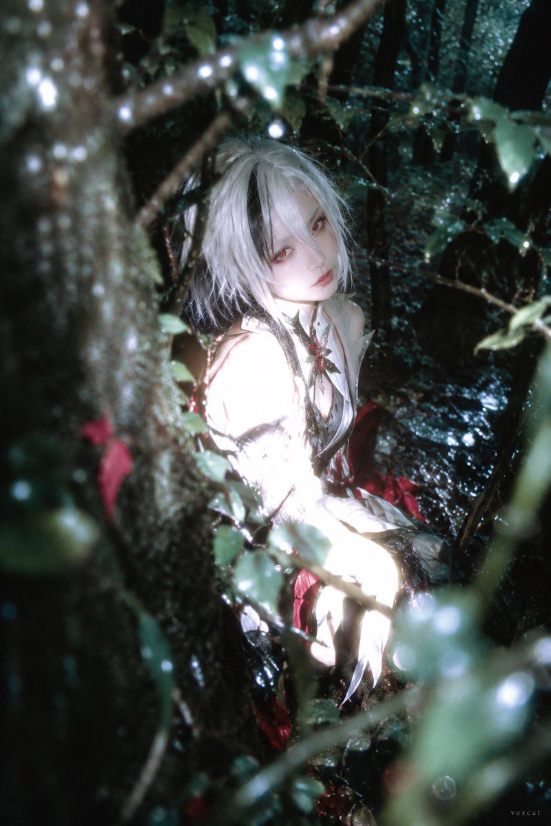 Close Flash Overexposes a Figure Turning Inside a Deep Green Forest