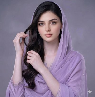 Elegant woman in lavender chiffon poses with serene gaze