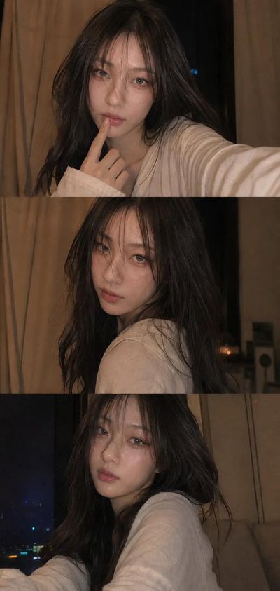 Woman in candid selfie with finger to her lips at night