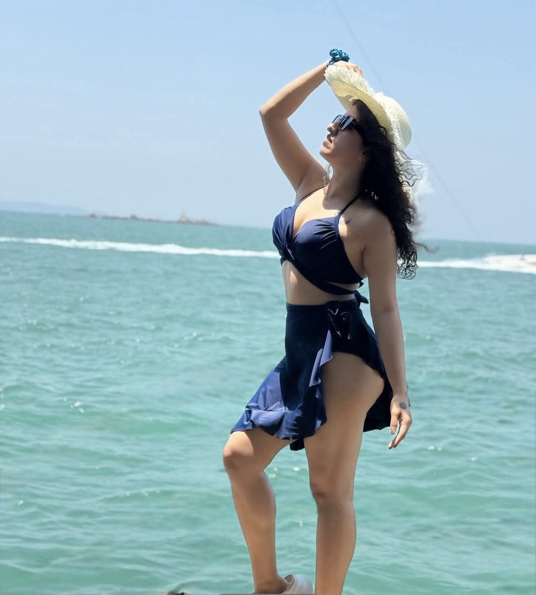 Golden Hour Beach Pose with Curly Hair and Turquoise Waves