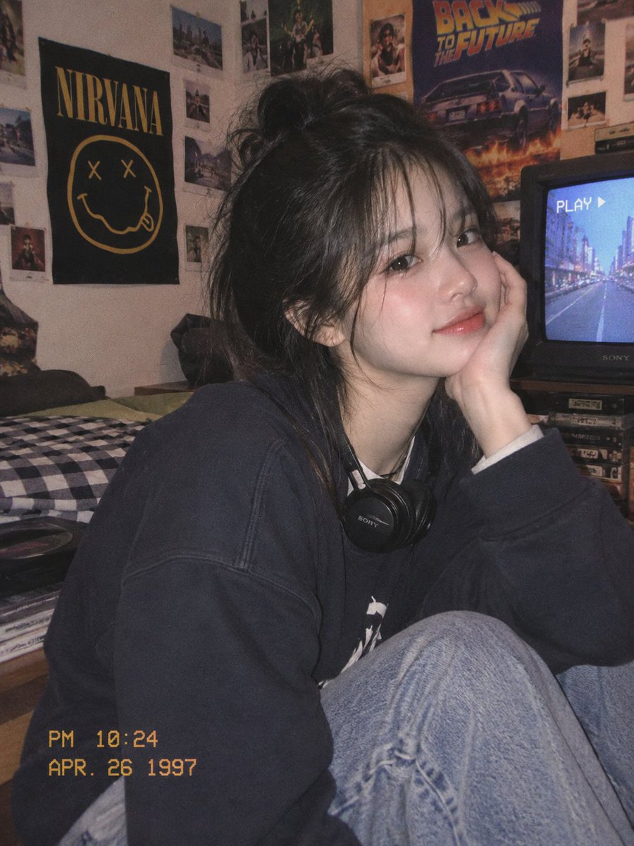 A Korean couple shares a cozy 90s bedroom moment together