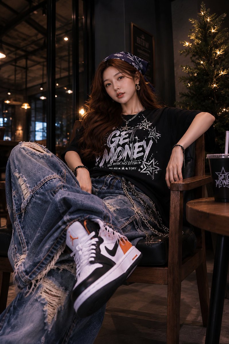 Young woman in oversized jeans relaxes in a leather armchair