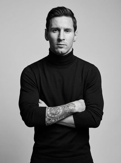 Confident man in black turtleneck stares directly at camera