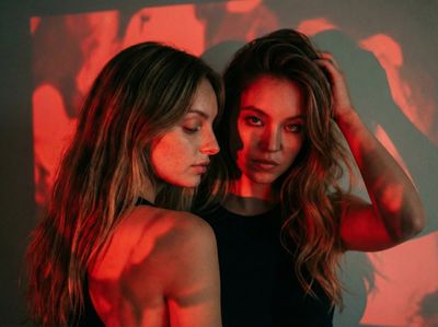 Red Light Reverie: Sydney Sweeney & Maya in Cinematic Portrait