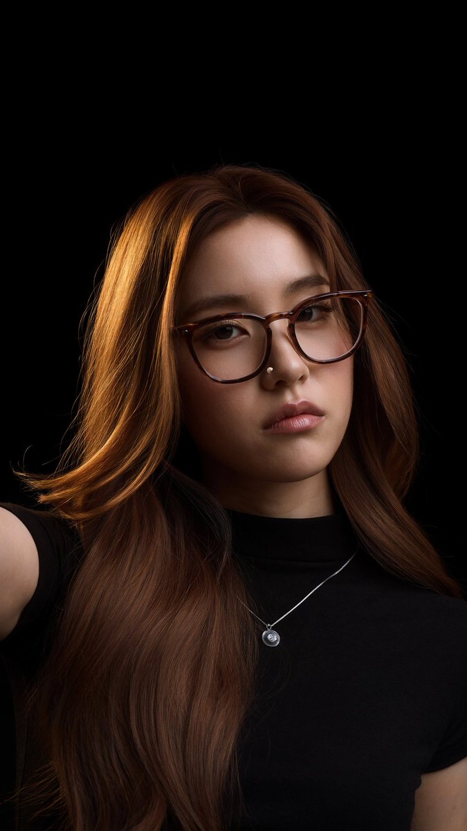 Young woman with glasses captures a warm selfie in black turtleneck