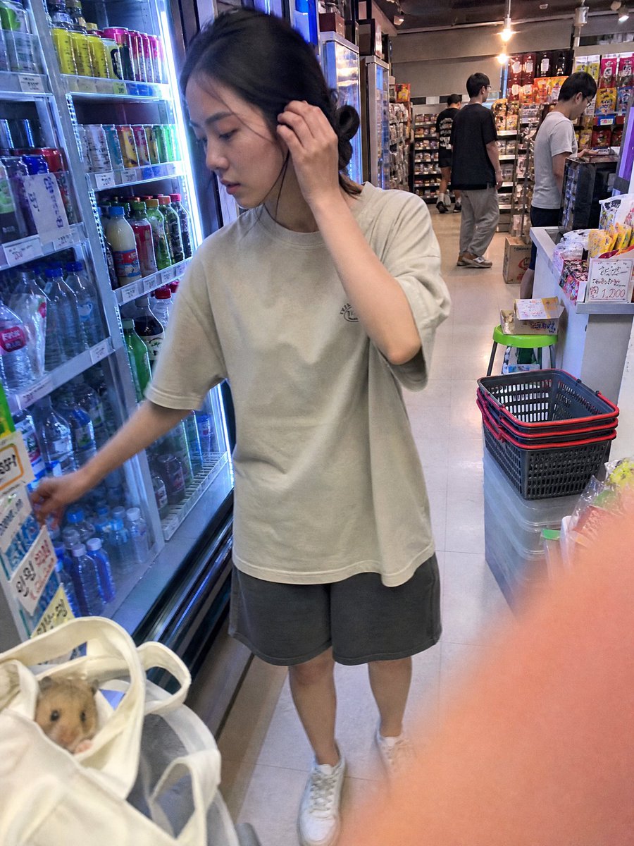 Candid Moment: Young Woman Grabs a Beverage in Convenience Store