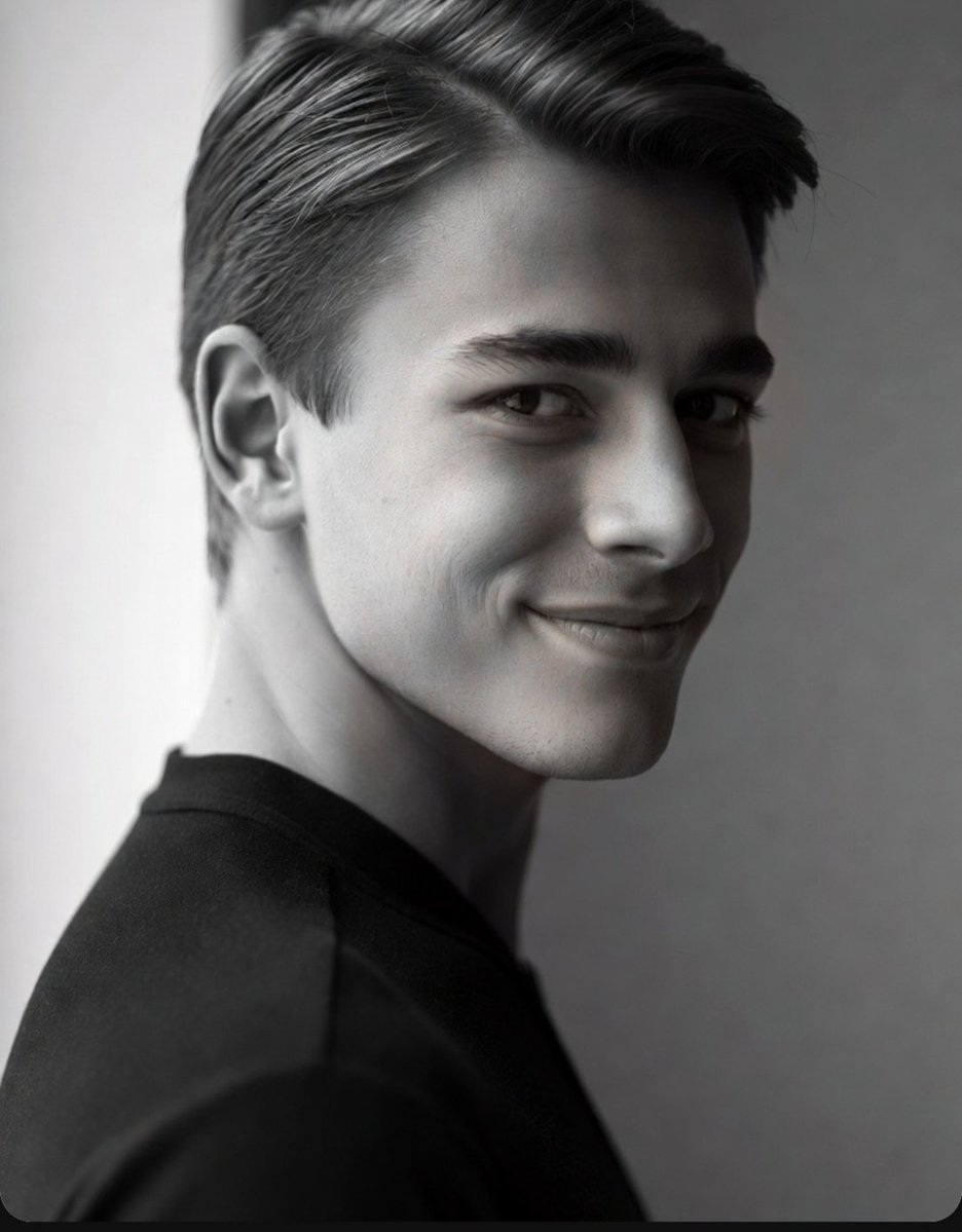 Young man's confident smile in a classic black and white portrait
