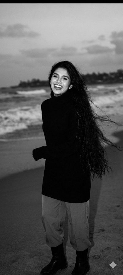 A laughing woman with long hair runs on a windy beach
