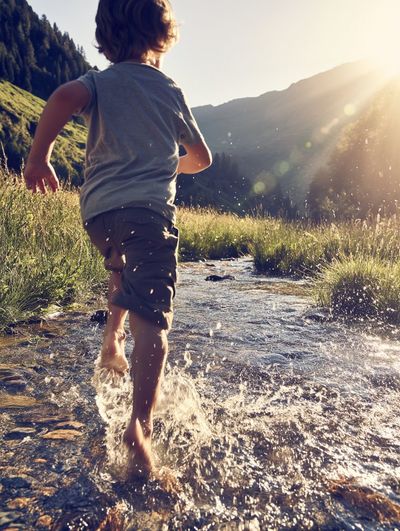 Barefoot Runner Embracing Dawn’s Glow on Open Terrain