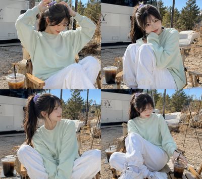 Young woman tying her hair in a sunny campsite portrait