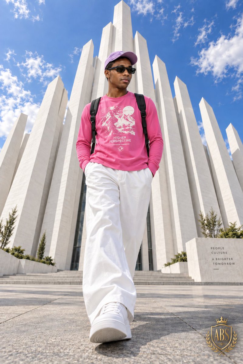 Low-angle streetwear portrait of man walking before white pillars