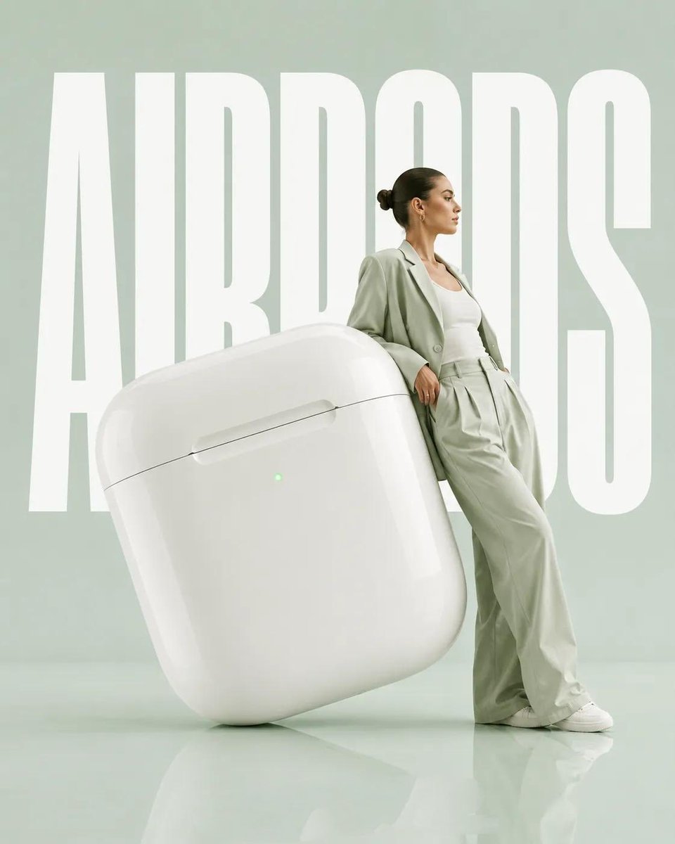 Oversized citrus sculpture supports a model in monochromatic editorial pose
