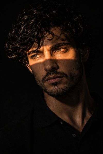 A mysterious man with a golden light beam across his eyes